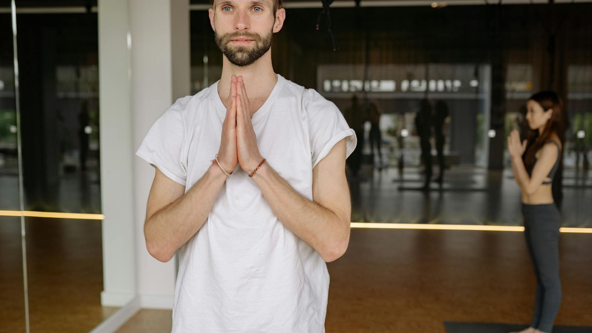 Calm and focused person practicing yoga in a serene studio.