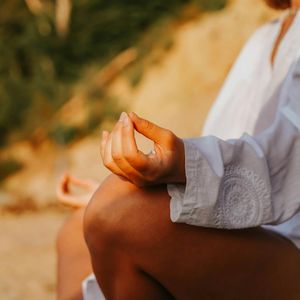 Close-up of hands in a meditative mudra position.