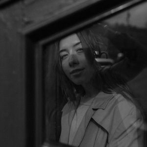 Silhouette of a person in a balance pose against a window.